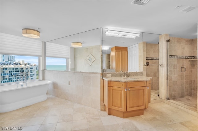 bathroom featuring tile walls, separate shower and tub, tile floors, and large vanity