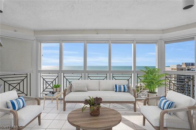 sunroom featuring a water view