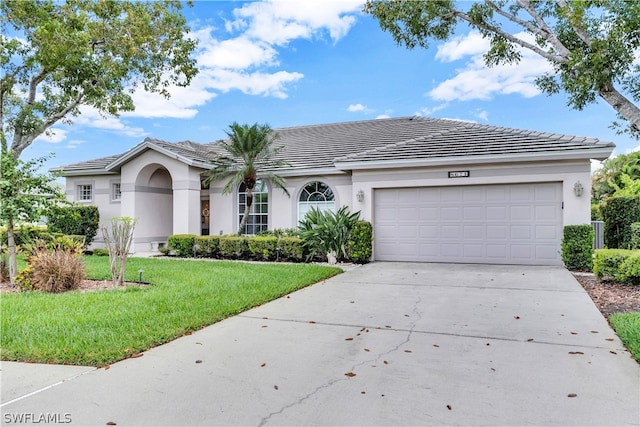 ranch-style home with a front lawn and a garage