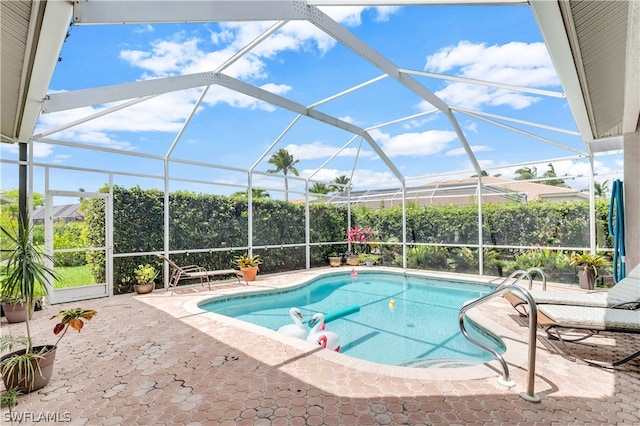 view of pool with a patio area and a lanai