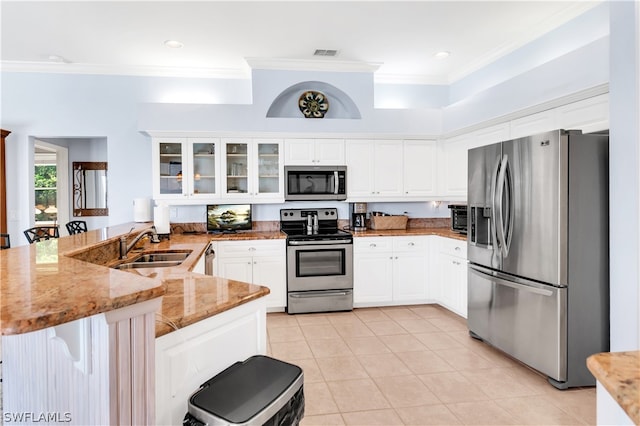 kitchen with stainless steel appliances, light tile floors, light stone countertops, kitchen peninsula, and sink