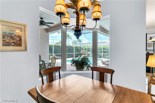 dining room featuring ceiling fan with notable chandelier