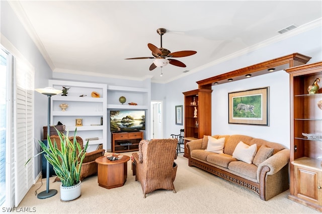 carpeted living room with crown molding and ceiling fan