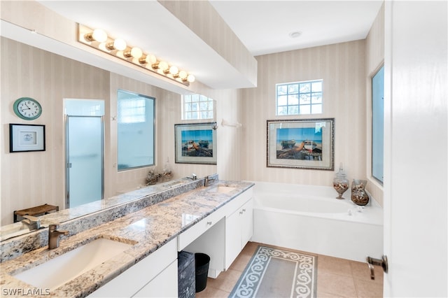 bathroom featuring double sink vanity, tile flooring, and a bath to relax in