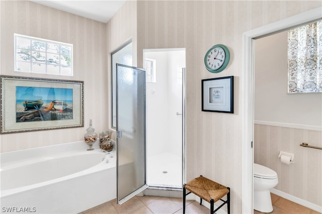 bathroom featuring tile flooring, toilet, and separate shower and tub