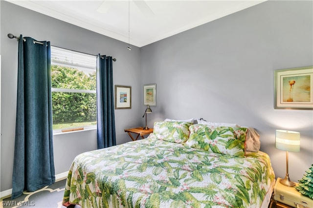 bedroom with ceiling fan and ornamental molding