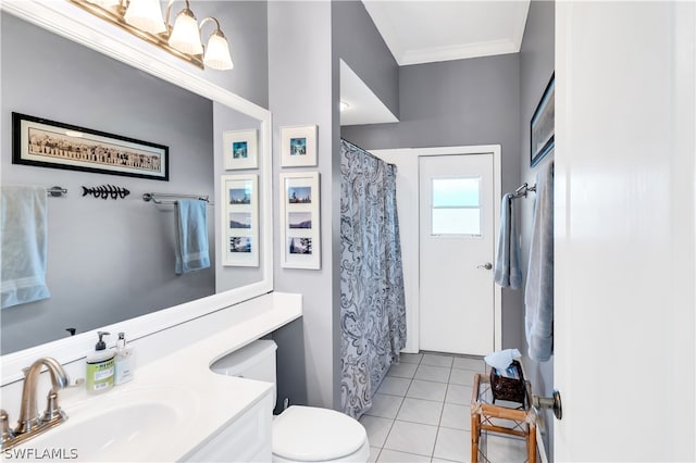 bathroom featuring tile floors, toilet, ornamental molding, and vanity