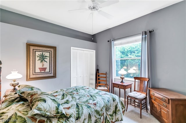 bedroom featuring light carpet, a closet, and ceiling fan