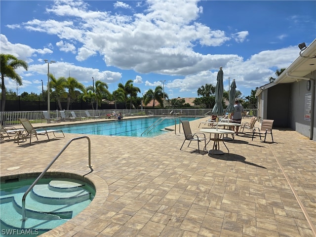 view of pool with a community hot tub and a patio area