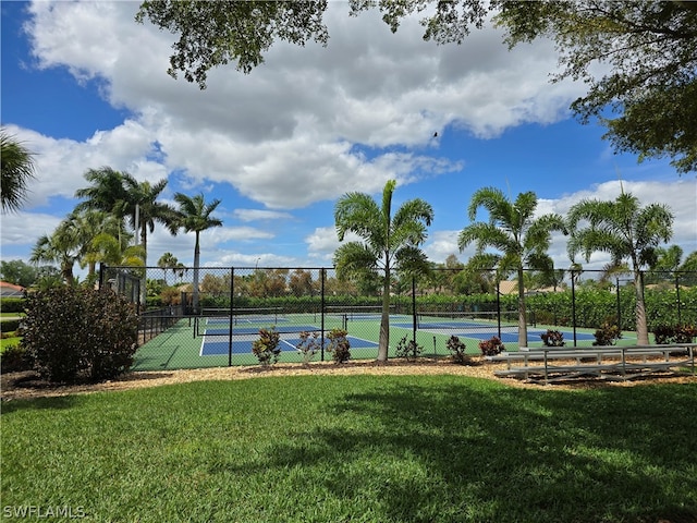 view of tennis court with a yard