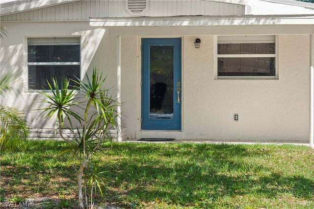 entrance to property with a yard