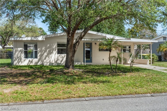 ranch-style home featuring a front yard and a carport