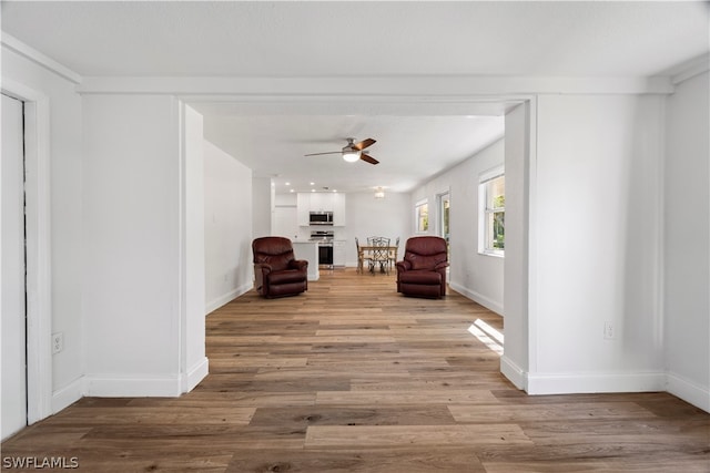 sitting room with light hardwood / wood-style flooring and ceiling fan