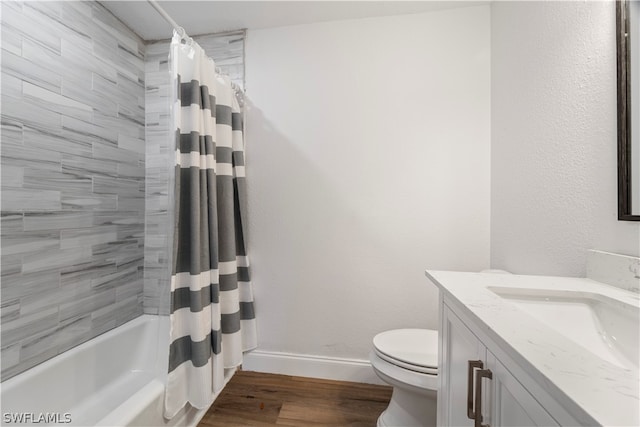 full bathroom with shower / bath combo with shower curtain, toilet, vanity, and hardwood / wood-style flooring