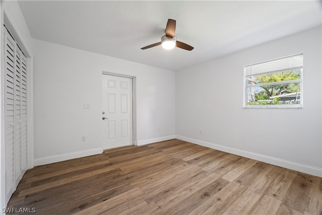 interior space with wood-type flooring and ceiling fan