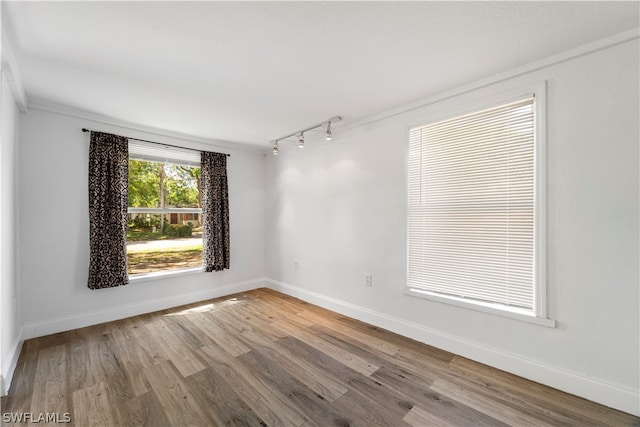 unfurnished room featuring light hardwood / wood-style floors and track lighting