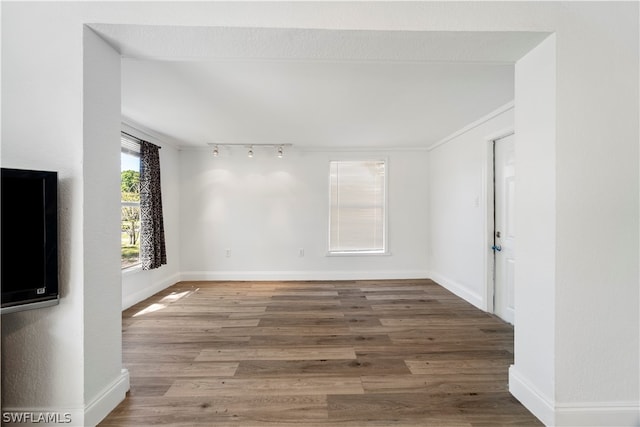 interior space with dark hardwood / wood-style flooring and track lighting