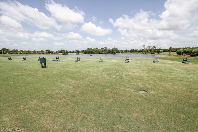 surrounding community featuring a water view and a yard