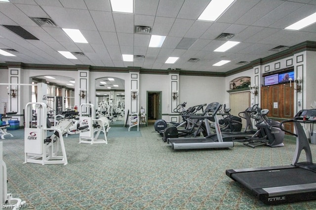 workout area featuring ornamental molding and a drop ceiling