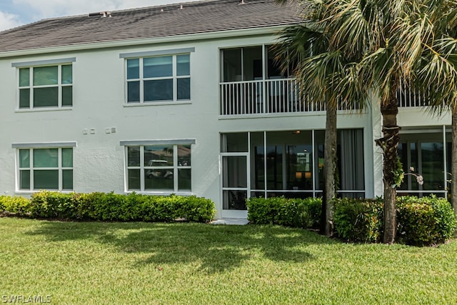 rear view of property featuring a yard