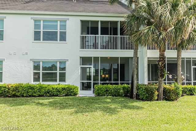 rear view of property with a lawn