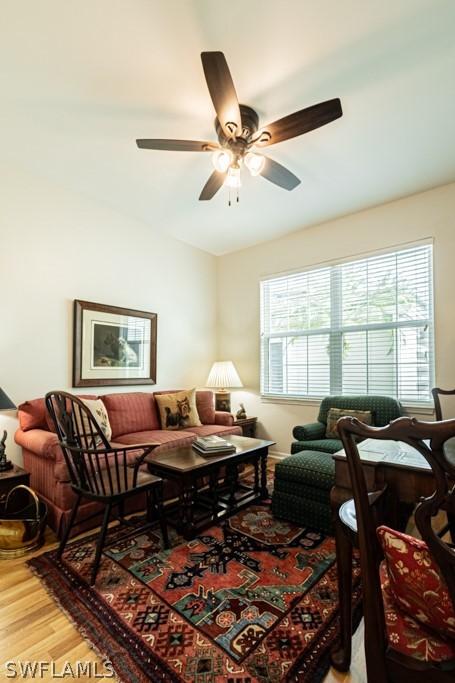 living room with ceiling fan and wood-type flooring