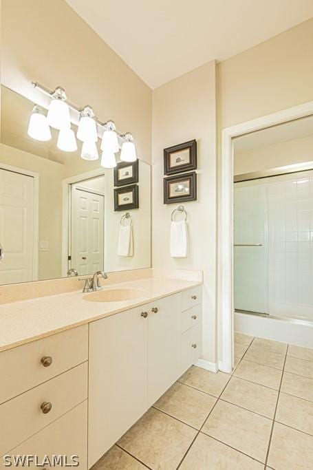 bathroom with tile patterned floors, vanity, and an enclosed shower