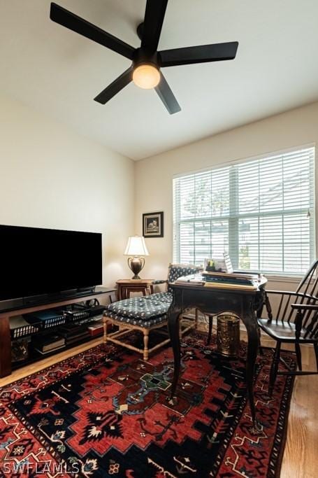 interior space featuring wood-type flooring and ceiling fan