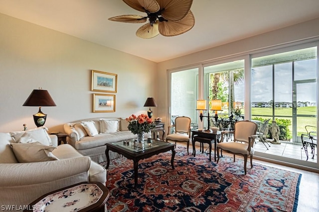 living room featuring hardwood / wood-style floors and ceiling fan