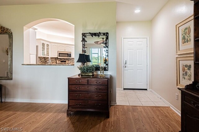 corridor with light hardwood / wood-style flooring