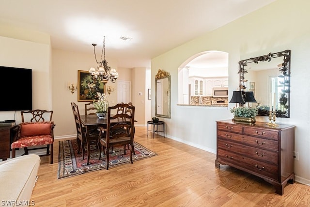 dining space featuring a chandelier and light hardwood / wood-style flooring