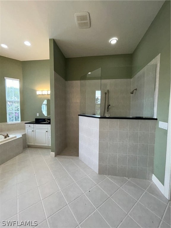 bathroom featuring vanity, tile patterned flooring, and independent shower and bath