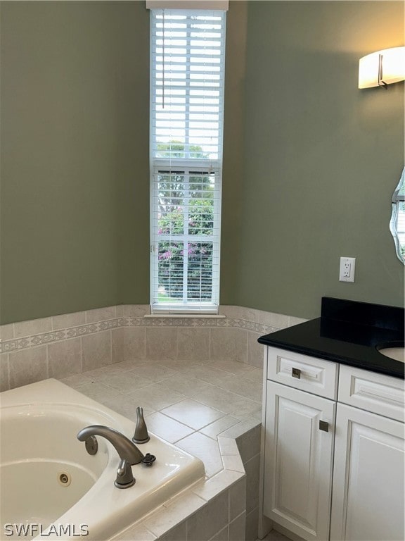 bathroom with tiled bath and vanity