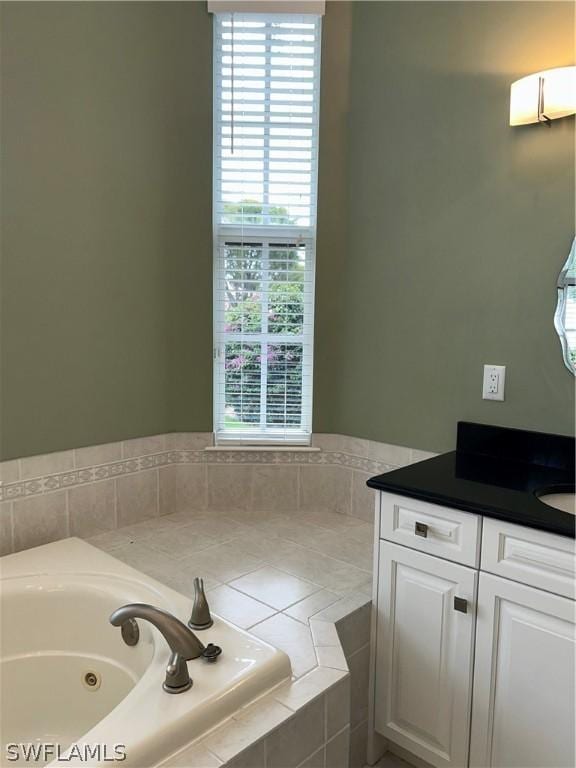 full bathroom with vanity and a whirlpool tub