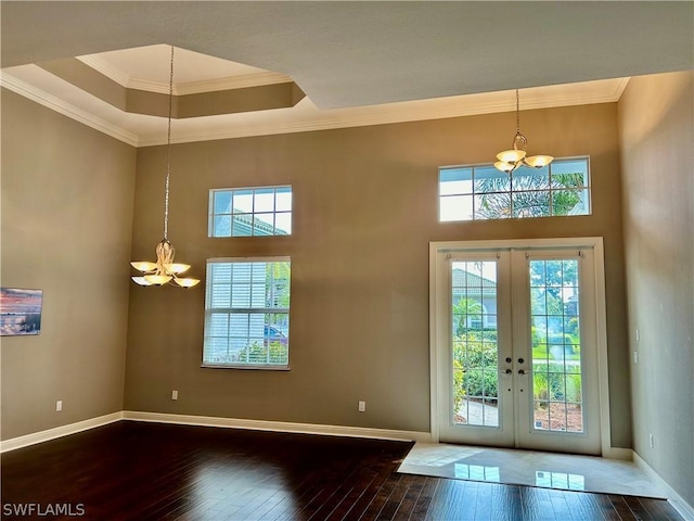 doorway with french doors, hardwood / wood-style floors, and crown molding