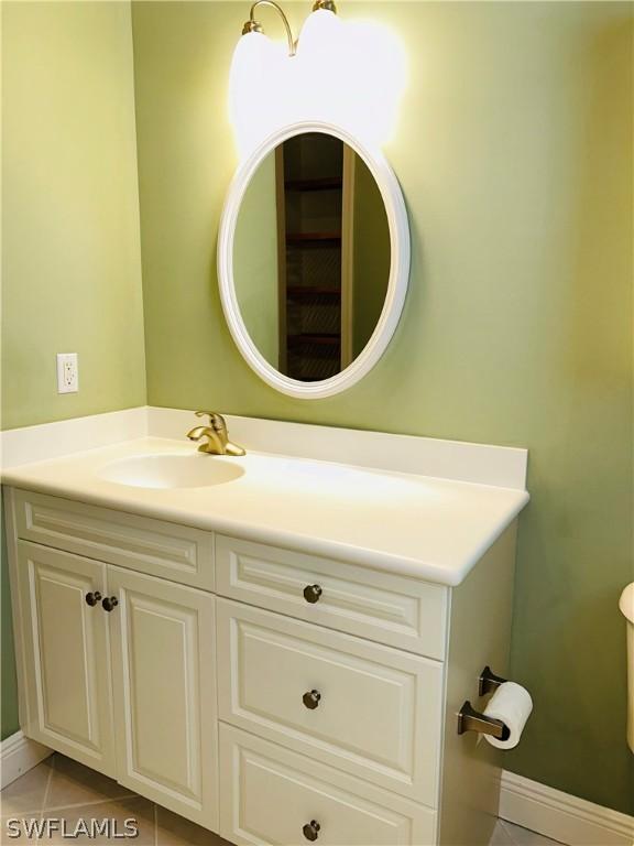 bathroom featuring baseboards, vanity, and tile patterned floors