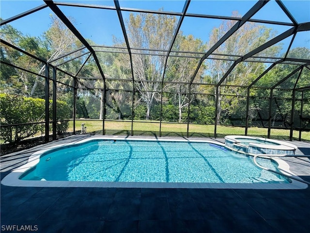 view of pool with glass enclosure, a patio area, and an in ground hot tub