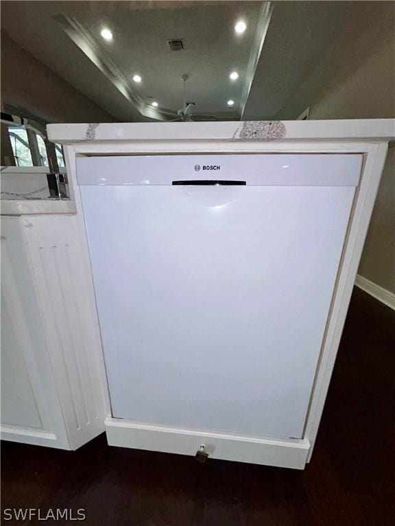 details featuring visible vents, a raised ceiling, wood finished floors, white dishwasher, and recessed lighting