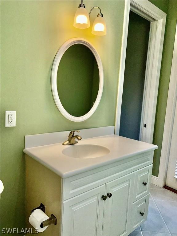 bathroom with tile patterned floors and vanity