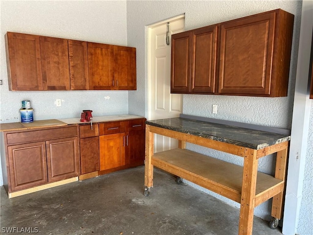 kitchen with concrete floors and brown cabinetry