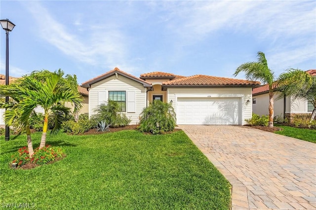 mediterranean / spanish-style home featuring a garage and a front yard