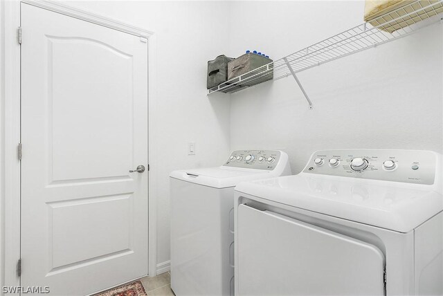 laundry area featuring light tile patterned flooring and separate washer and dryer