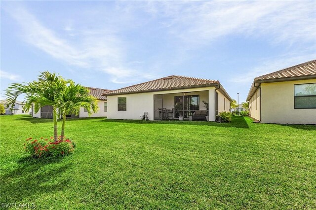 rear view of property with a yard