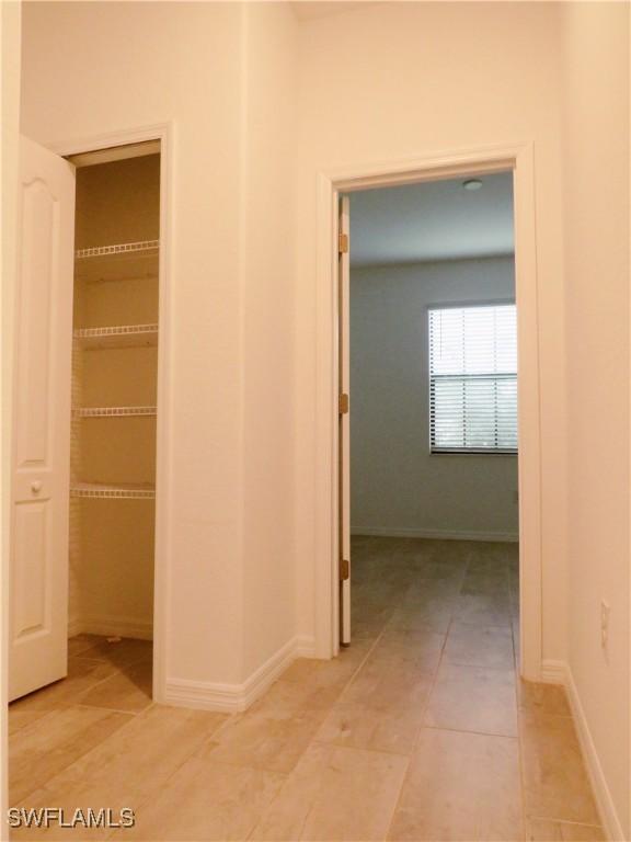 hallway featuring light tile patterned flooring