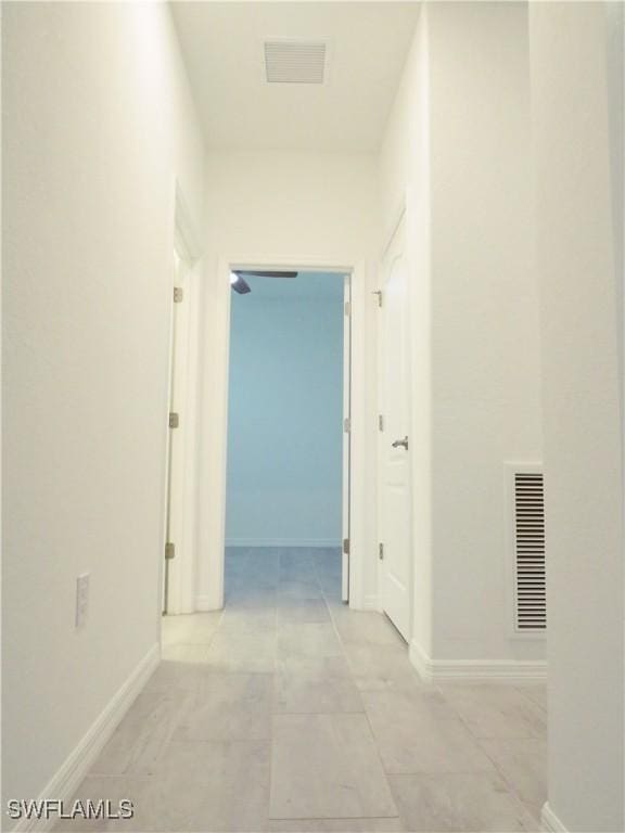 hall featuring light tile patterned floors