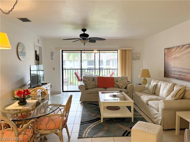 living room featuring light tile floors and ceiling fan