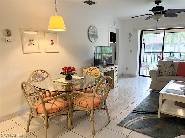 dining area featuring light tile floors and ceiling fan