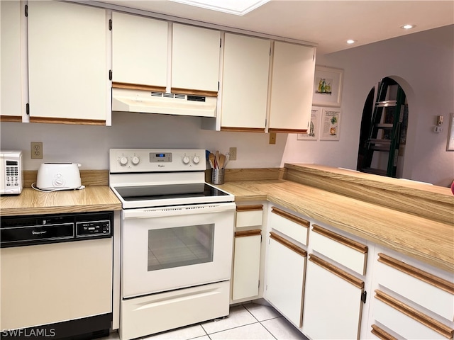 kitchen featuring white appliances, white cabinets, and light tile floors