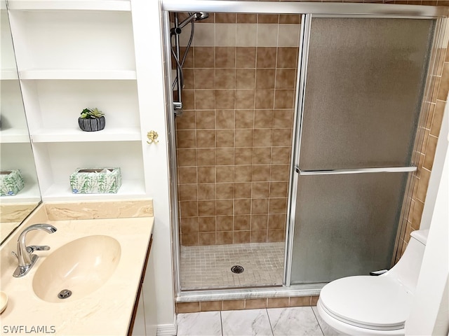 bathroom featuring toilet, built in shelves, an enclosed shower, tile flooring, and oversized vanity