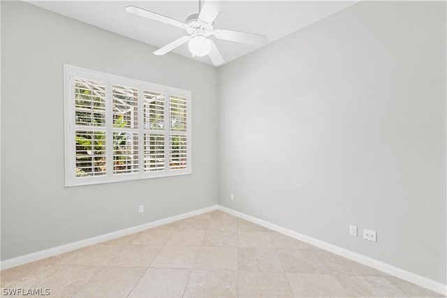 tiled spare room featuring ceiling fan